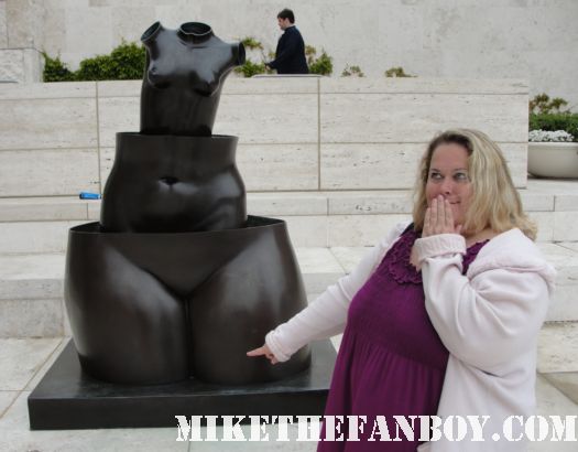 pinky pointing to a sculptures vagina at the getty center in los angeles botanical sculpture garden tim curry