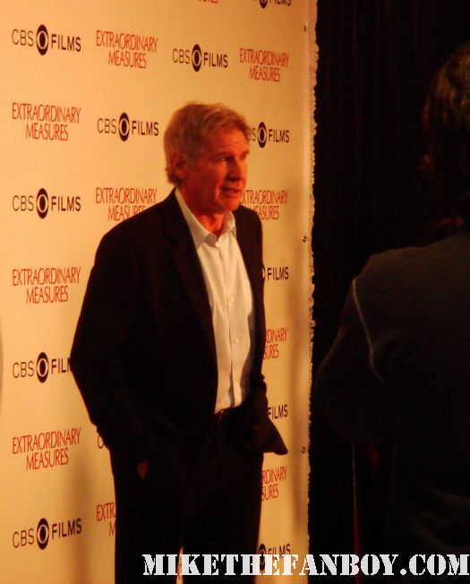 harrison ford and Meredith Groeger pose on the red carpet for a press screening of extraordinary measures