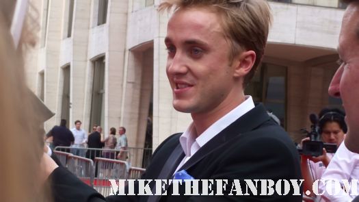 tom felton signing autographs for fans at the the harry potter and the deathly hallows part 2 new york movie premiere waiting fans for the red carpet daniel radcliffe