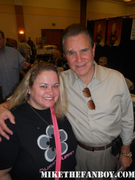 rich little from well the 60's at  the burbank hollywood collector's show at the hollywood collector's show poses for a fan photo with pinky from pretty in pinky