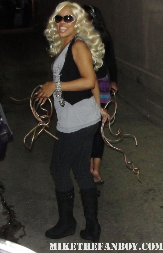 a woman with super long nails arrives to the jimmy kimmel show.  Her nails looks like snakes