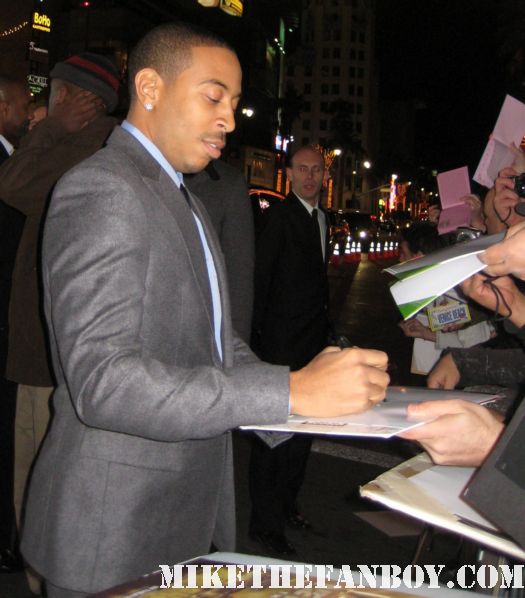 Ludacris arrives the new years eve world movie premiere and signs autographs for fans
