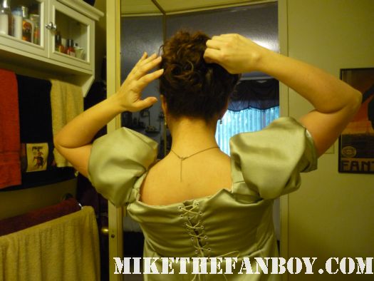 Pinning hair up the novel strumpet from mike the fanboy putting on a tam preparing to go to the jane austin ball in los angeles put on by the Society for Manners and Merriment in the district of Los Angeles known as Pasadena
