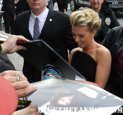 sexy scarlett johansson black widow  signs autographs for fans at the avengers world movie premiere on the red carpet with chris hemsworth chris evans samuel l jackson and more