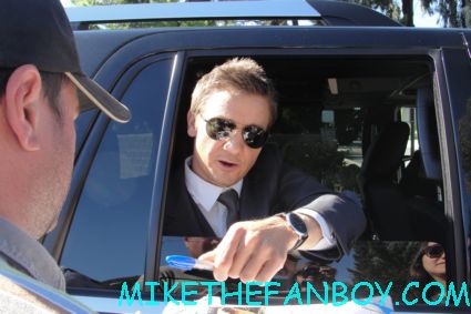 sexy jeremy renner signing autographs for fans while promoting the bourne legacy suit and tie