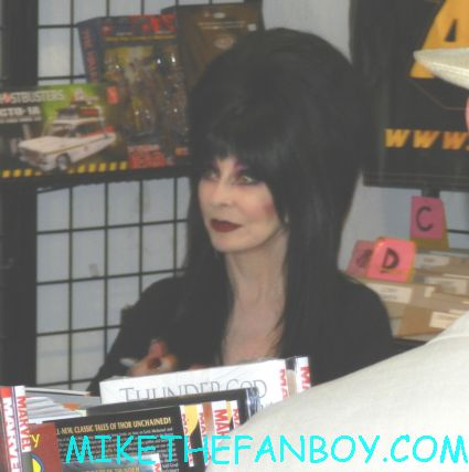 elvira mistress of the dark signing autographs for fans at golden apple comics in los angeles looking hot and sexy elvira arriving in front of golden apple comics to sign autographs for fans looking hot and sexy elvira mistress of the dark