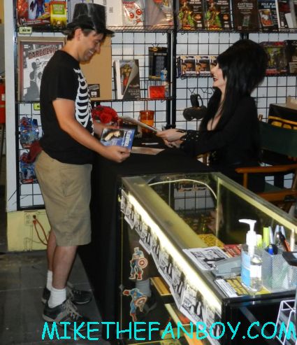  elvira mistress of the dark signing autographs for fans at golden apple comics in los angeles looking hot and sexy elvira arriving in front of golden apple comics to sign autographs for fans looking hot and sexy elvira mistress of the dark