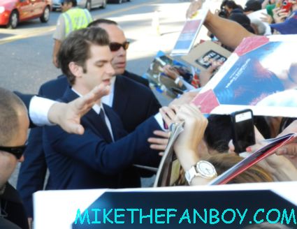 andrew garfield signing autographs for fans at the a man dressed up like spider man on the red carpet The amazing spider man world movie premiere with andrew garfield emma stone rhys ifans rare signing autographs for fans