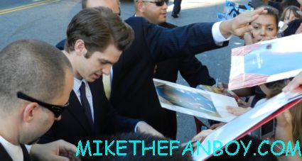 andrew garfield signing autographs for fans at the a man dressed up like spider man on the red carpet The amazing spider man world movie premiere with andrew garfield emma stone rhys ifans rare signing autographs for fans