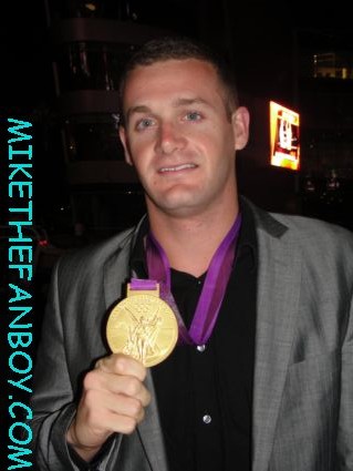 olympian star tyler clary posing with his gold medal at the movie premiere for hit and run
