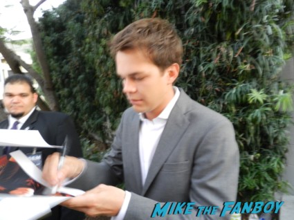 Johnny Simmons signs autographs for fans on the red carpet at the perks of a wallflower movie premiere rare promo signed