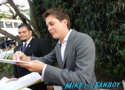 Johnny Simmons signs autographs for fans on the red carpet at the perks of a wallflower movie premiere rare promo signed