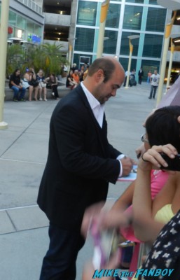 ian gomez from cougar town signing autographs for fans at the words movie premiere with bradley cooper and zoe saldana
