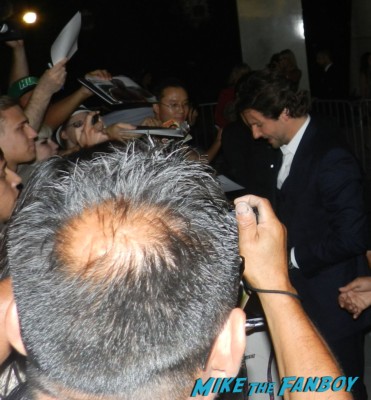 sexy hot bradley cooper signing autographs for fans at the words movie premiere with bradley cooper and zoe saldana