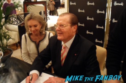 Roger Moore signing autographs for fans at his bond on bond book signing at harrod's in london rare signature promo