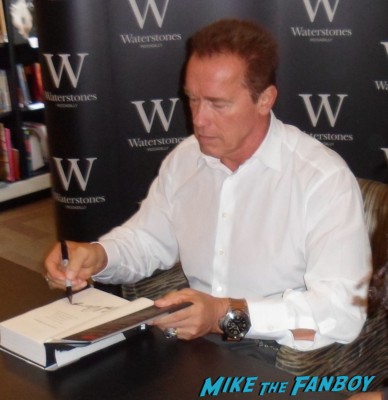 Arnold Schwarzenegger signing autographs for fans at his book signing for Total Recall: My Unbelievably True Life Story