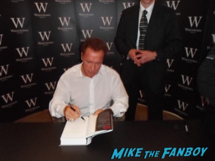 Arnold Schwarzenegger signing autographs for fans at his book signing for  Total Recall: My Unbelievably True Life Story