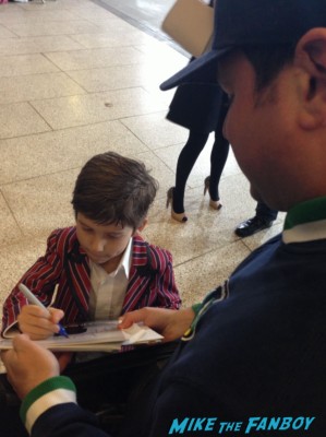 a little boy signing autographs for fans the dark skies movie premiere at the arclight cinerama dome signing autographs