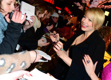 michelle williams signing autographs for fans at the oz the great and powerful movie premiere in London UK
