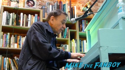 Richard M. Sherman signing autographs for fans and playing music at an instore signing