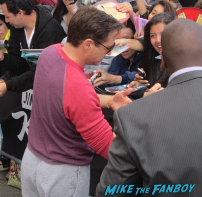 robert downey jr. signing autographs for fans before a talk show taping