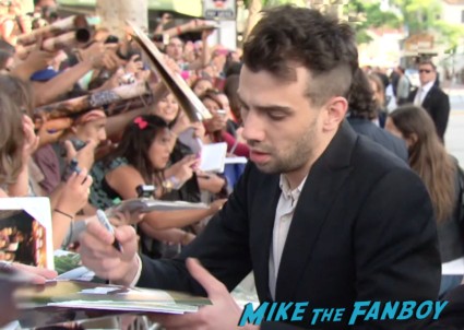 Jay Baruchel signing autographs for fans This Is The End Movie Premiere red carpet
