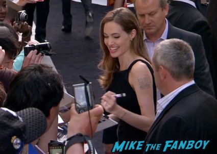 Angelina Jolie signing autographs for fans World War z movie premiere london brad pitt angelina jolie signing autographs red carpet (11)