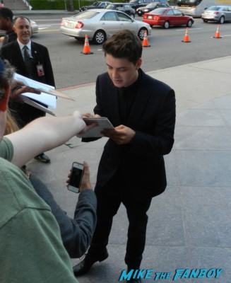 Israel Broussard signing autographs at the bling ring movie premiere emma watson signing autographs 038