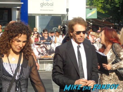 Jerry Bruckheimer signing autographs for fans at the uk premiere of The Lone Ranger