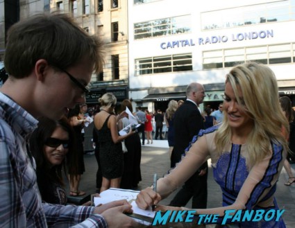 Ashley Roberts signing autographs for fans at the uk premiere of The Lone Ranger