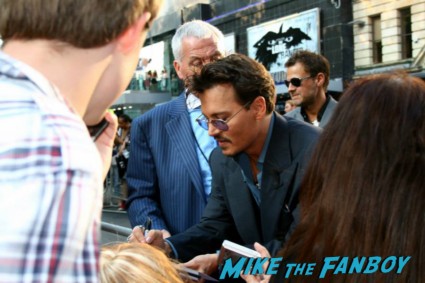 Johnny Depp signing autographs for fans at the uk premiere of The Lone Ranger