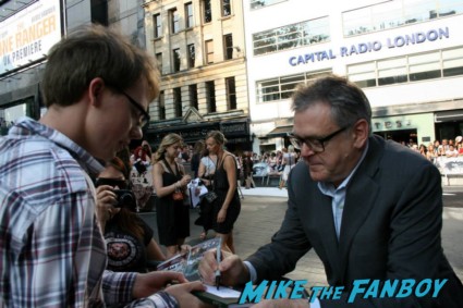 Kevin Mcnally signing autographs for fans at the uk premiere of The Lone Ranger