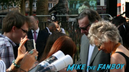 Tom Wilkinson signing autographs for fans at the uk premiere of The Lone Ranger
