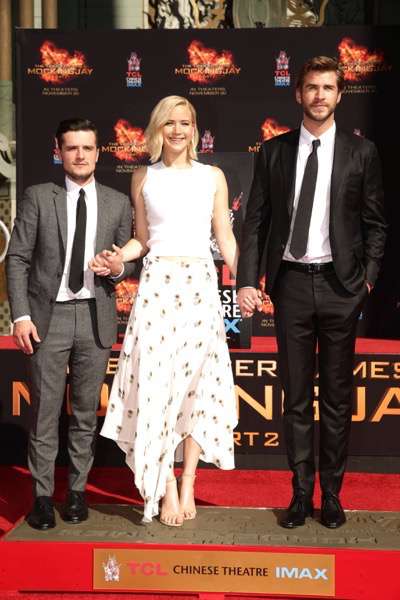 Josh Hutcherson, Jennifer Lawrence and Liam Hemsworth seen at The Hunger Games: Mockingjay Part 2 cast Hand and footprint ceremony at Hollywood Blvd. on Saturday, October 31, 2015, in Los Angeles, CA. (Photo by Eric Charbonneau/Invision for Lionsgate/AP Images)