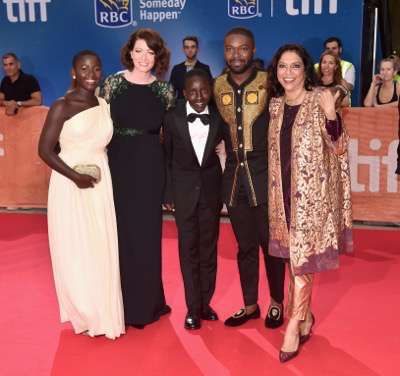 TORONTO, ON - SEPTEMBER 10: (L-R) Mark Mugwana, President of Walt Disney Studios Motion Picture Production, Sean Bailey, producer John Carls, actor David Oyelowo, Ugandan national chess champion Phiona Mutesi, actor Martin Kabanza, Chess Coach and Director of Sports Outreach in Uganda, Robert Katende, actors Madina Nalwanga, Lupita Nyong'o, director Mira Nair, Chairman, The Walt Disney Studios, Alan Horn, producer Lydia Pilcher, President, Marketing, The Walt Disney Studios, Ricky Strauss, Executive Vice President of Production, The Walt Disney Studios, Tendo Nagenda and EVP, Distribution at The Walt Disney Company, Dave Hollis arrive at the world premiere of Disneyís ìQueen of Katweî at Roy Thompson Hall as part of the 2016 Toronto Film Festival where the cast, filmmakers and real life stars received a standing ovation. The film, starring David Oyelowo, Oscar winner Lupita Nyongío and newcomer Madina Nalwanga, is directed by Mira Nair and opens in U.S. Theaters September 23, 2017.  (Photo by Alberto E. Rodriguez/Getty Images for Disney ) *** Local Caption *** Mark Mugwana; Sean Bailey; John Carls; David Oyelowo; Phiona Mutesi; Martin Kabanza; Robert Katende; Madina Nalwanga; Lupita Nyong'o; Mira Nair; Alan Horn; Lydia Pilcher; Ricky Strauss; Tendo Nagenda; Dave Hollis