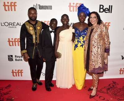 TORONTO, ON - SEPTEMBER 10: (L-R) Mark Mugwana, President of Walt Disney Studios Motion Picture Production, Sean Bailey, producer John Carls, actor David Oyelowo, Ugandan national chess champion Phiona Mutesi, actor Martin Kabanza, Chess Coach and Director of Sports Outreach in Uganda, Robert Katende, actors Madina Nalwanga, Lupita Nyong'o, director Mira Nair, Chairman, The Walt Disney Studios, Alan Horn, producer Lydia Pilcher, President, Marketing, The Walt Disney Studios, Ricky Strauss, Executive Vice President of Production, The Walt Disney Studios, Tendo Nagenda and EVP, Distribution at The Walt Disney Company, Dave Hollis arrive at the world premiere of Disneyís ìQueen of Katweî at Roy Thompson Hall as part of the 2016 Toronto Film Festival where the cast, filmmakers and real life stars received a standing ovation. The film, starring David Oyelowo, Oscar winner Lupita Nyongío and newcomer Madina Nalwanga, is directed by Mira Nair and opens in U.S. Theaters September 23, 2017.  (Photo by Alberto E. Rodriguez/Getty Images for Disney ) *** Local Caption *** Mark Mugwana; Sean Bailey; John Carls; David Oyelowo; Phiona Mutesi; Martin Kabanza; Robert Katende; Madina Nalwanga; Lupita Nyong'o; Mira Nair; Alan Horn; Lydia Pilcher; Ricky Strauss; Tendo Nagenda; Dave Hollis