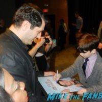 Iain Armitage with fans signing autographs